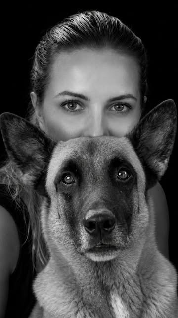 Black and white portrait of trainer and dog, trust-based dog training