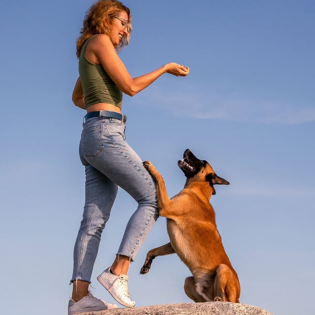 Trainer and her dog reaching out, positive dog training in Huatulco